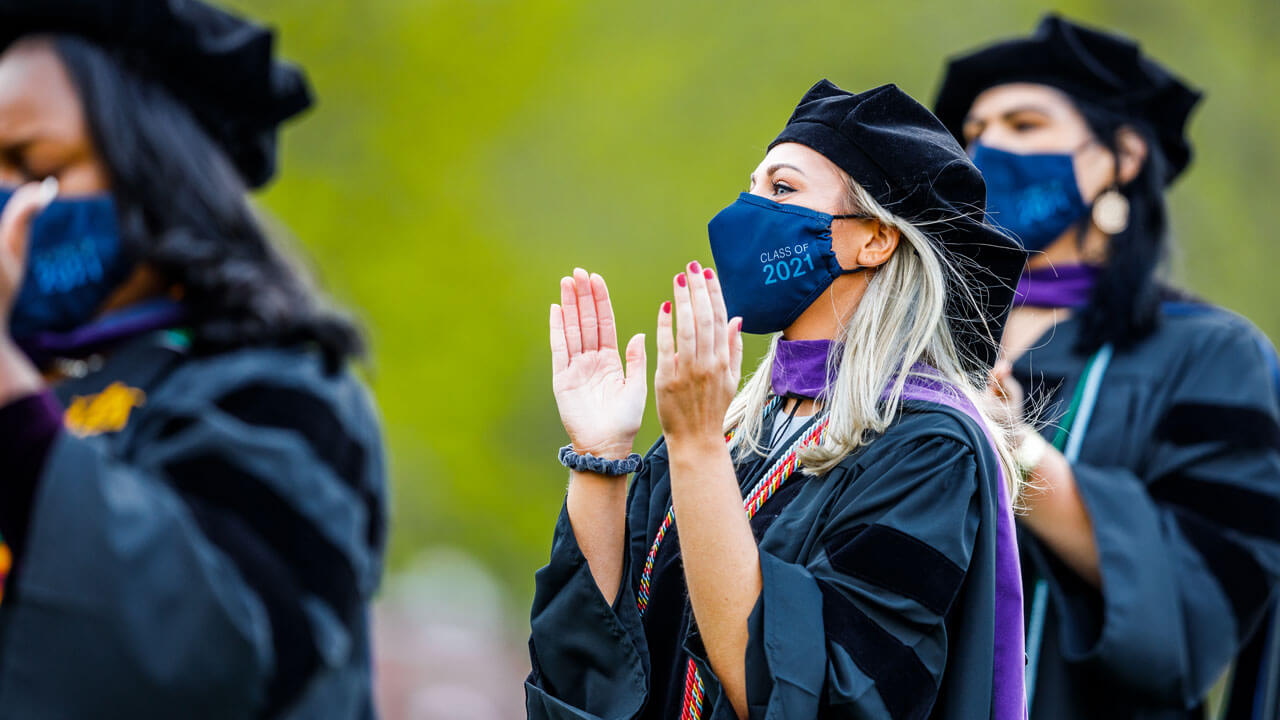 Graduates clap and cheer during the ceremony