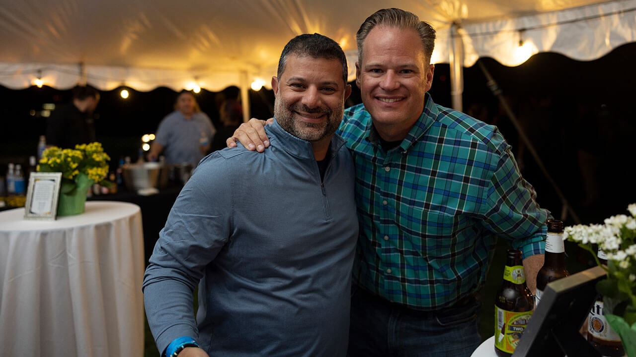 Two alumni smile for a photo during Bobcat Weekend festivities