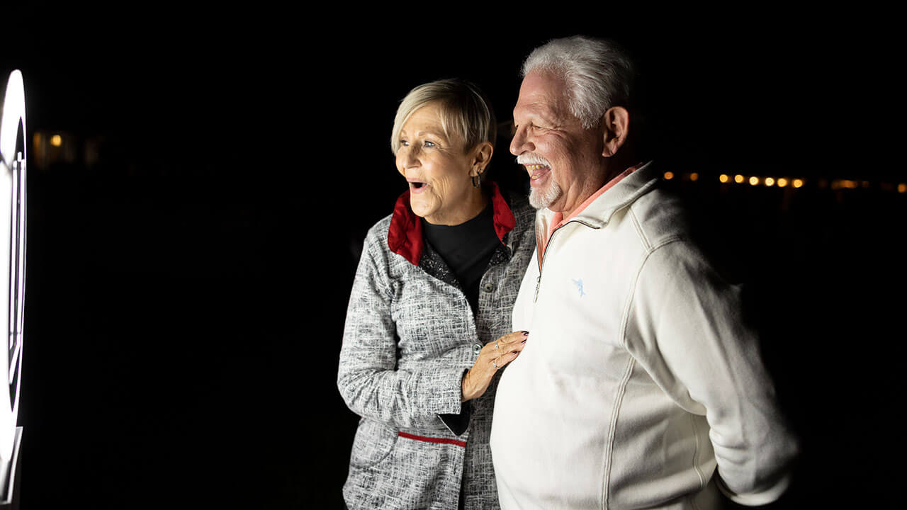 Alumni smile at the photo booth at a social event