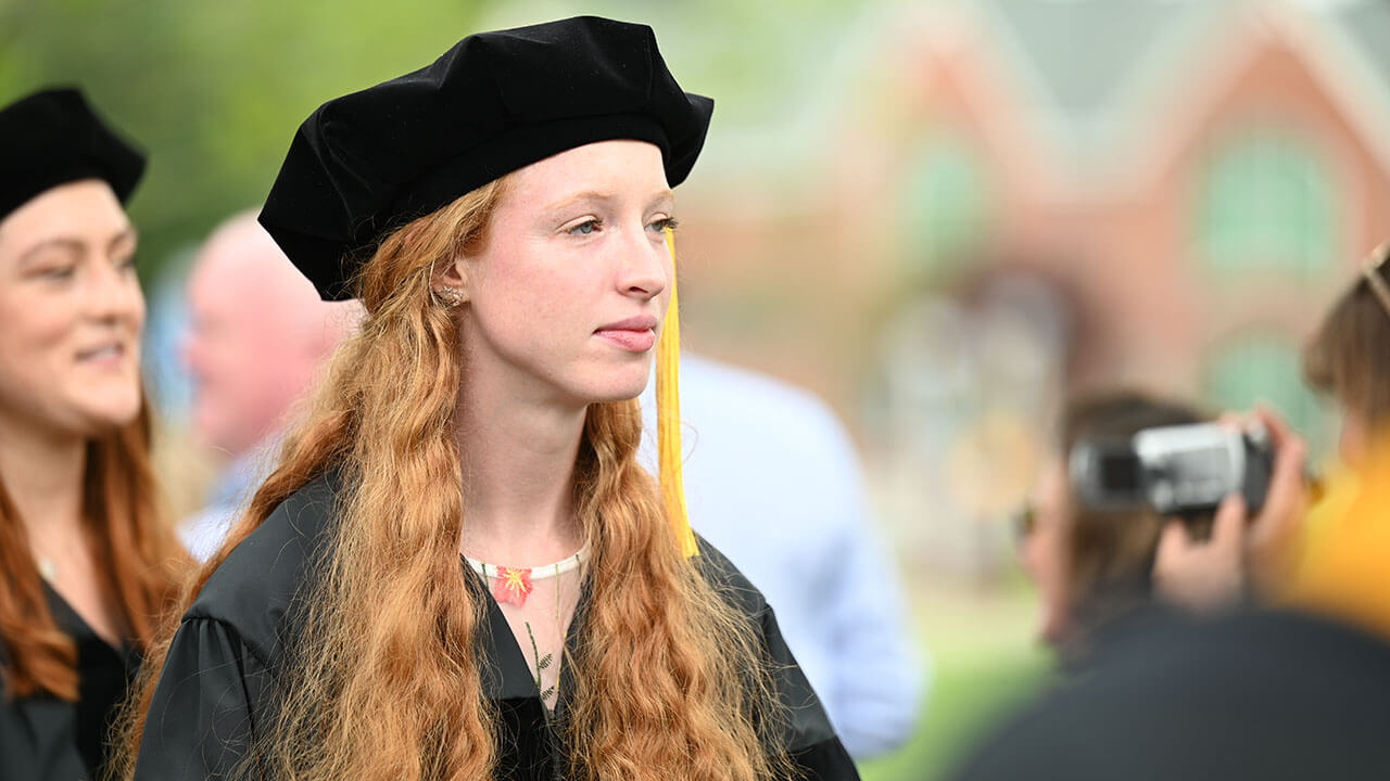 Graduate looks to the stage during the Commencement ceremony