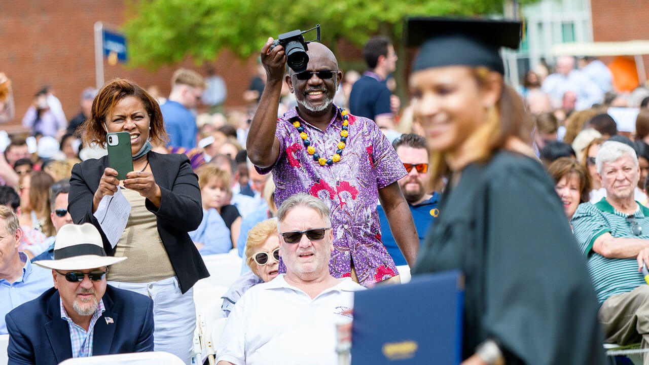 Parents taking photos of graduates