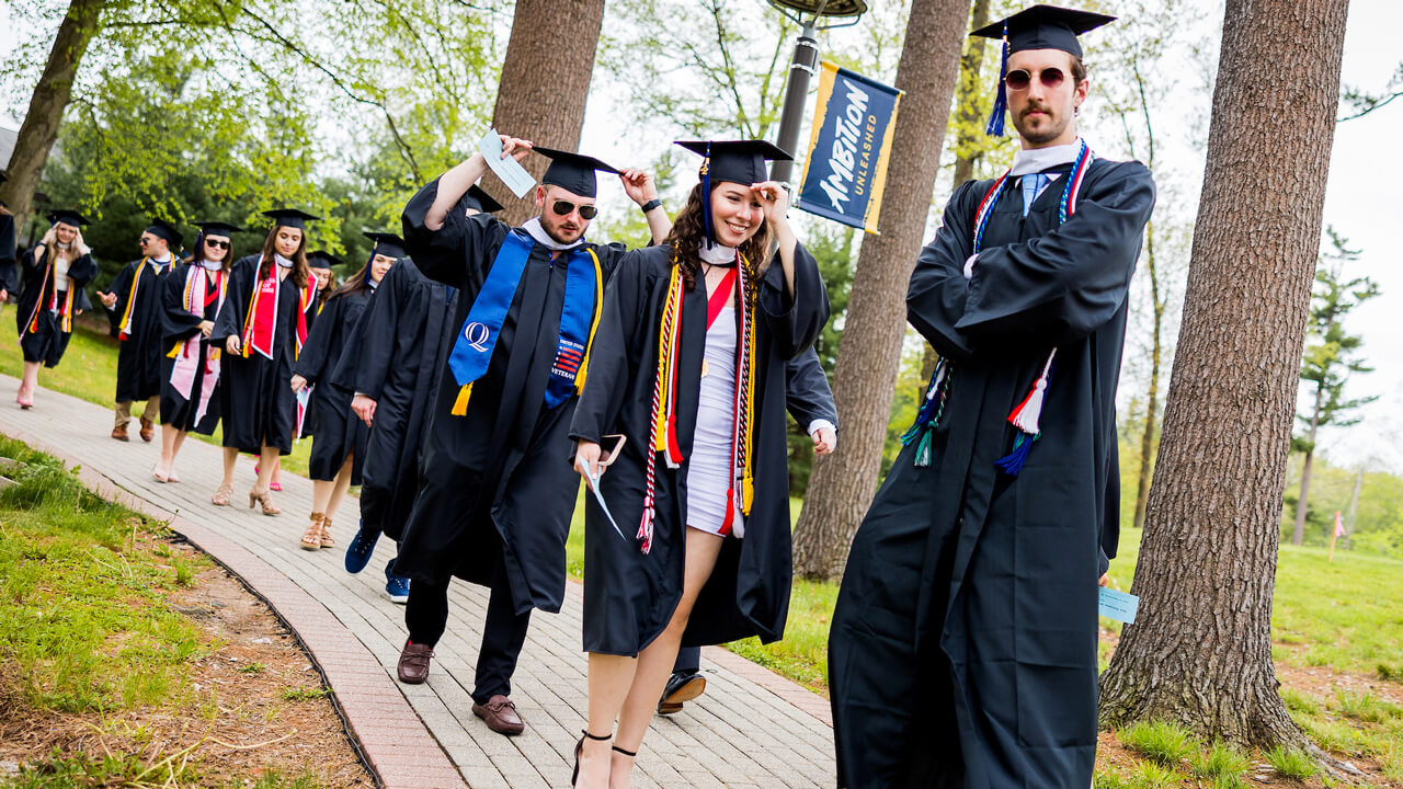 Graduate student poses with crossed arms for a photo