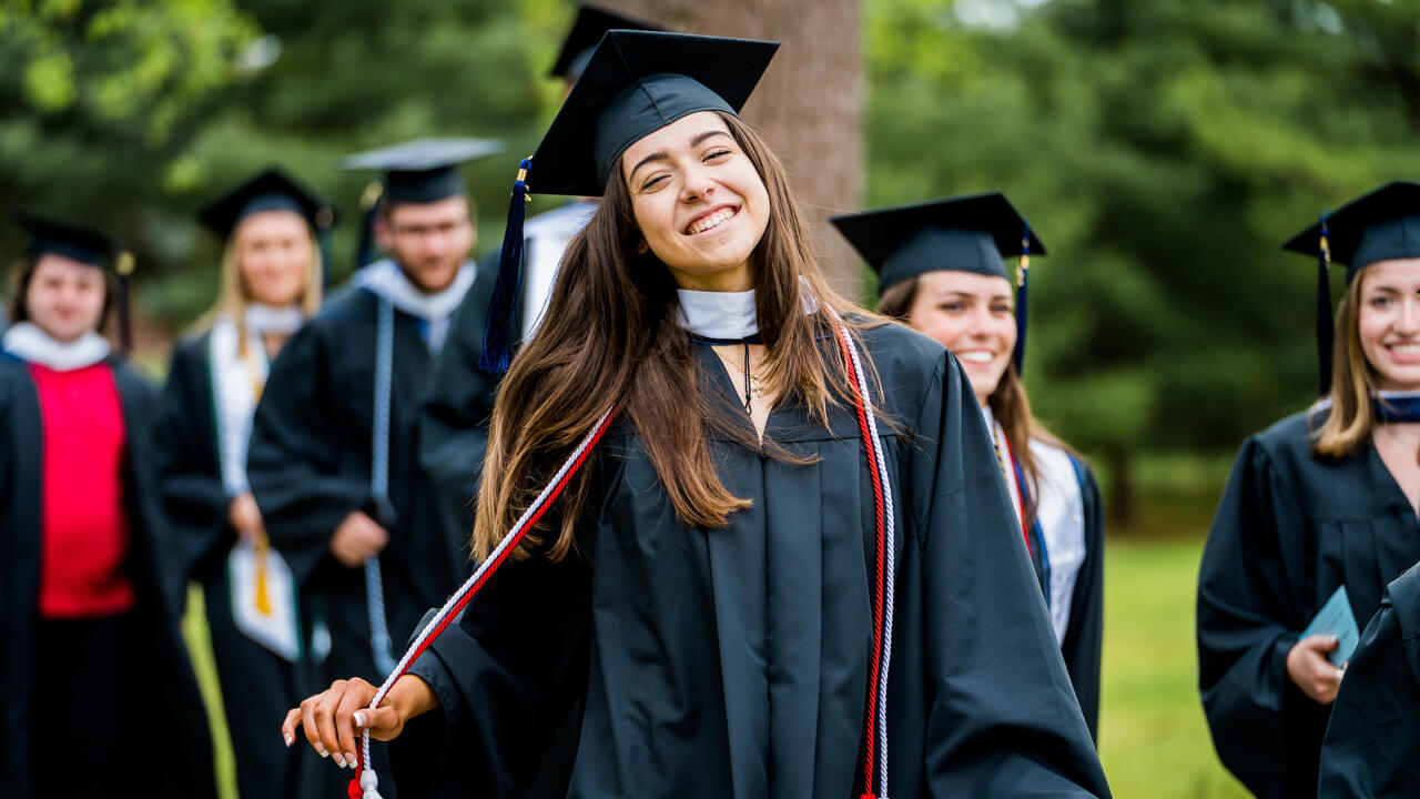 Graduate student grabs her cords as she walks