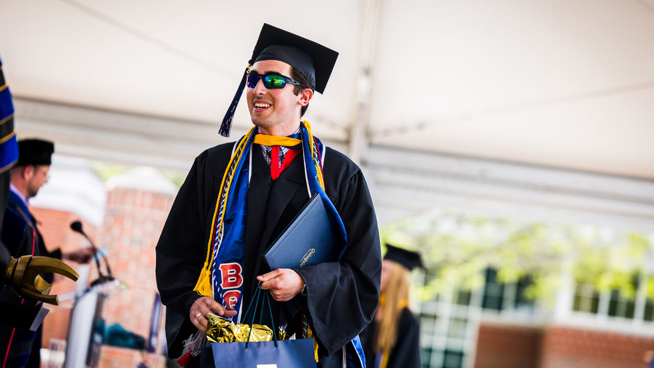 Graduate Nicholas Ciampanelli walks across the Commencement stage