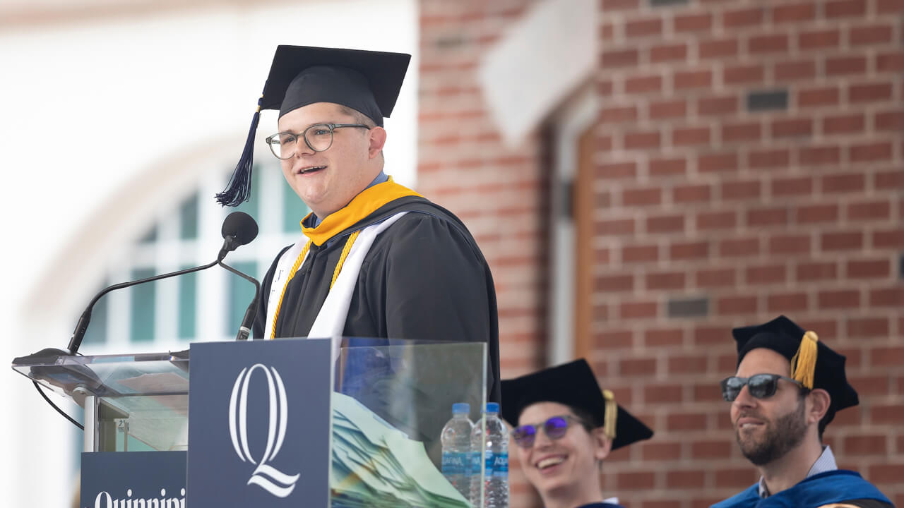 Chase Molinari speaks from the podium during Commencement