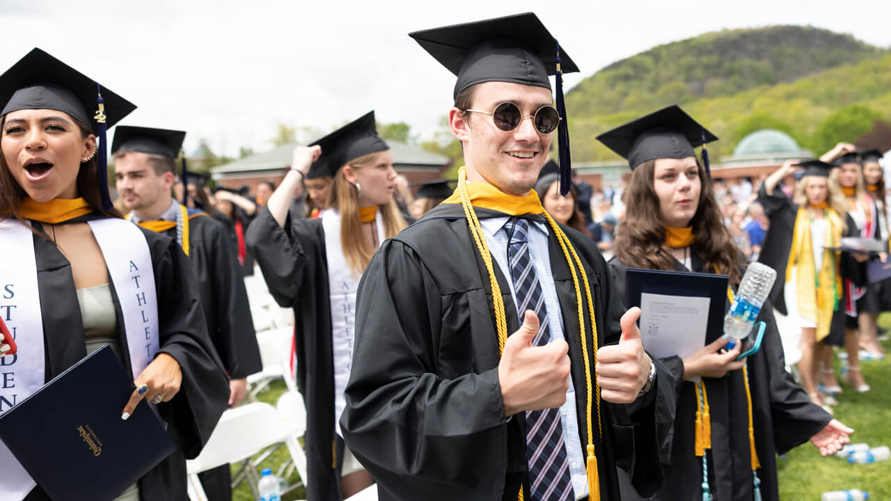 Graduates cheer from their seats during Commencement