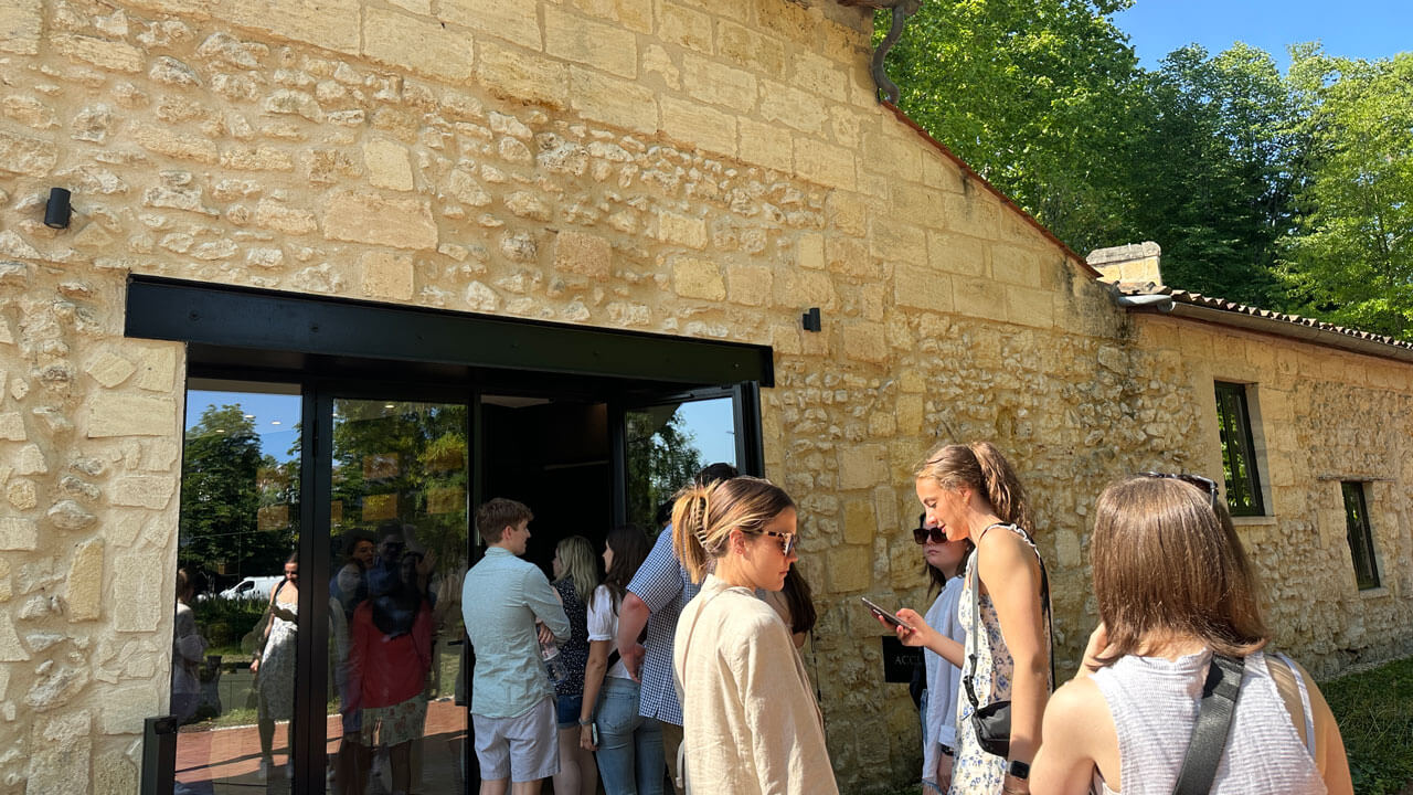 Group of students walking into vineyard's chateau