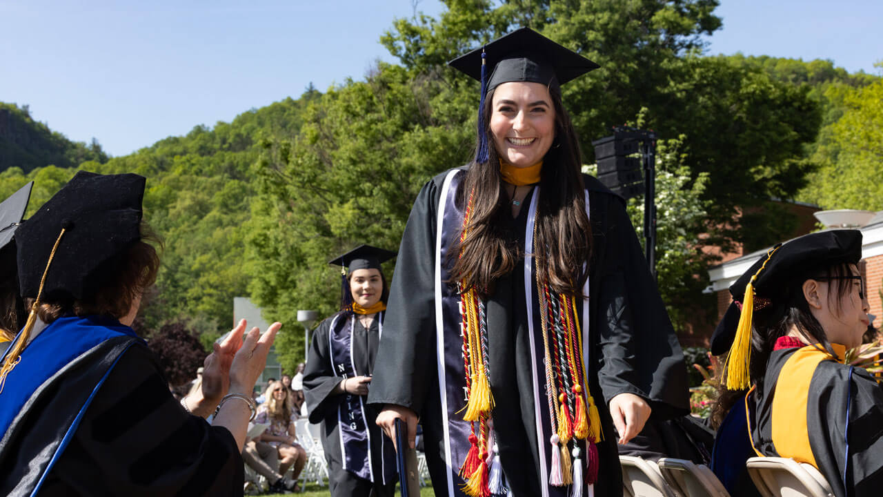 Graduates walking in line smiling