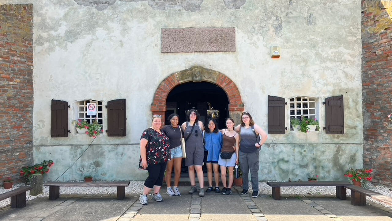 Students standing in front of a museum