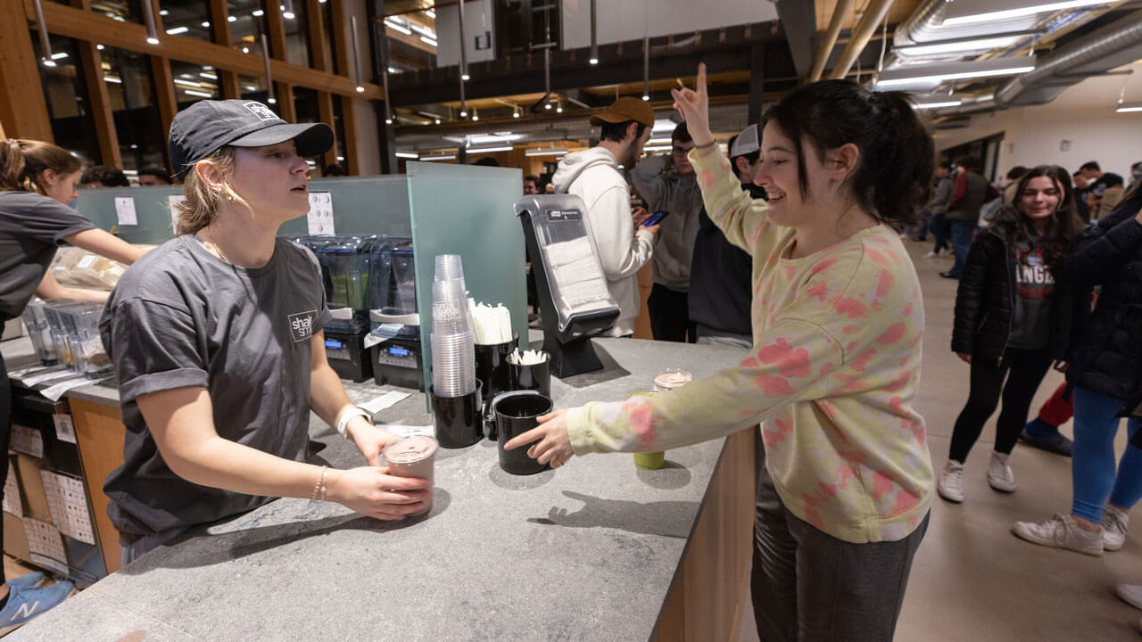 Student picks up shake at shakesmart during rec and wellness opening.