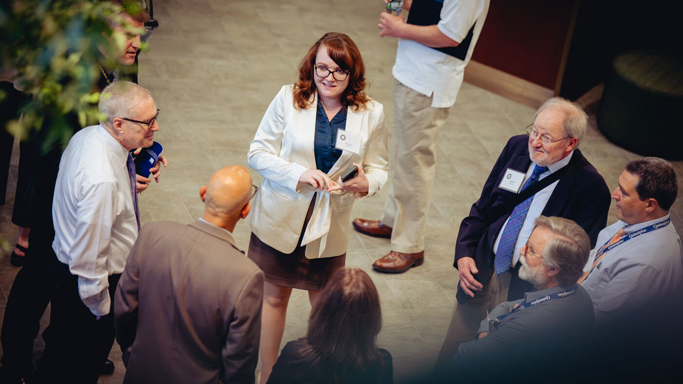 Faculty and attendees converse during an intermission.