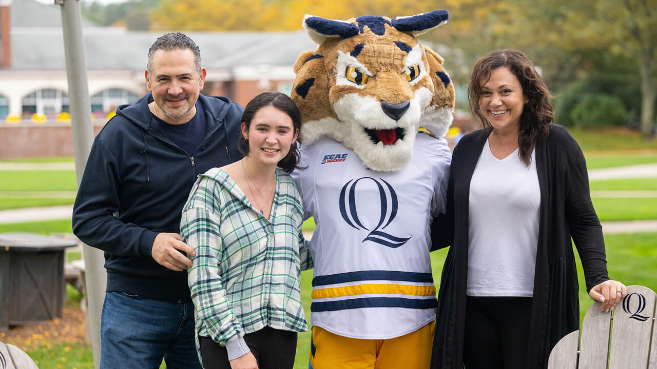 Family smiling for a photo with Boomer