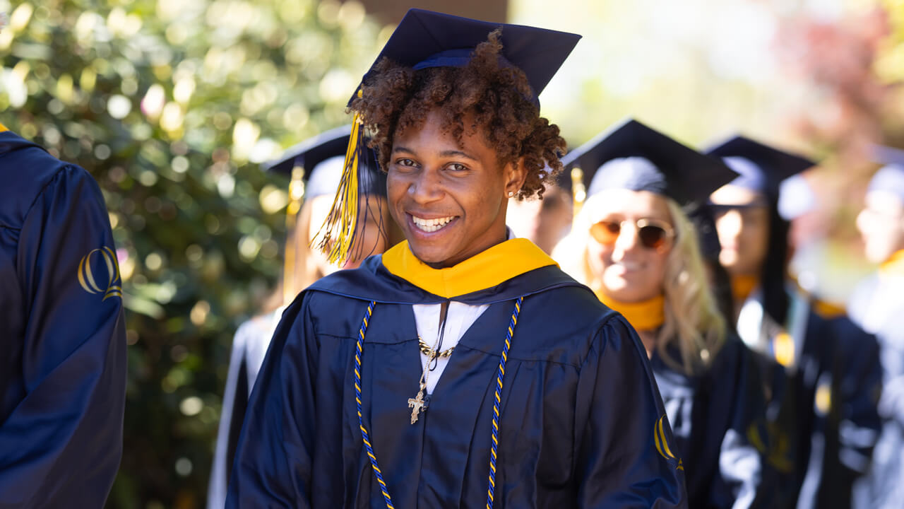 Student smiles at camera