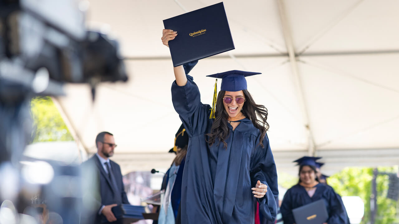 Student holds degree in the air