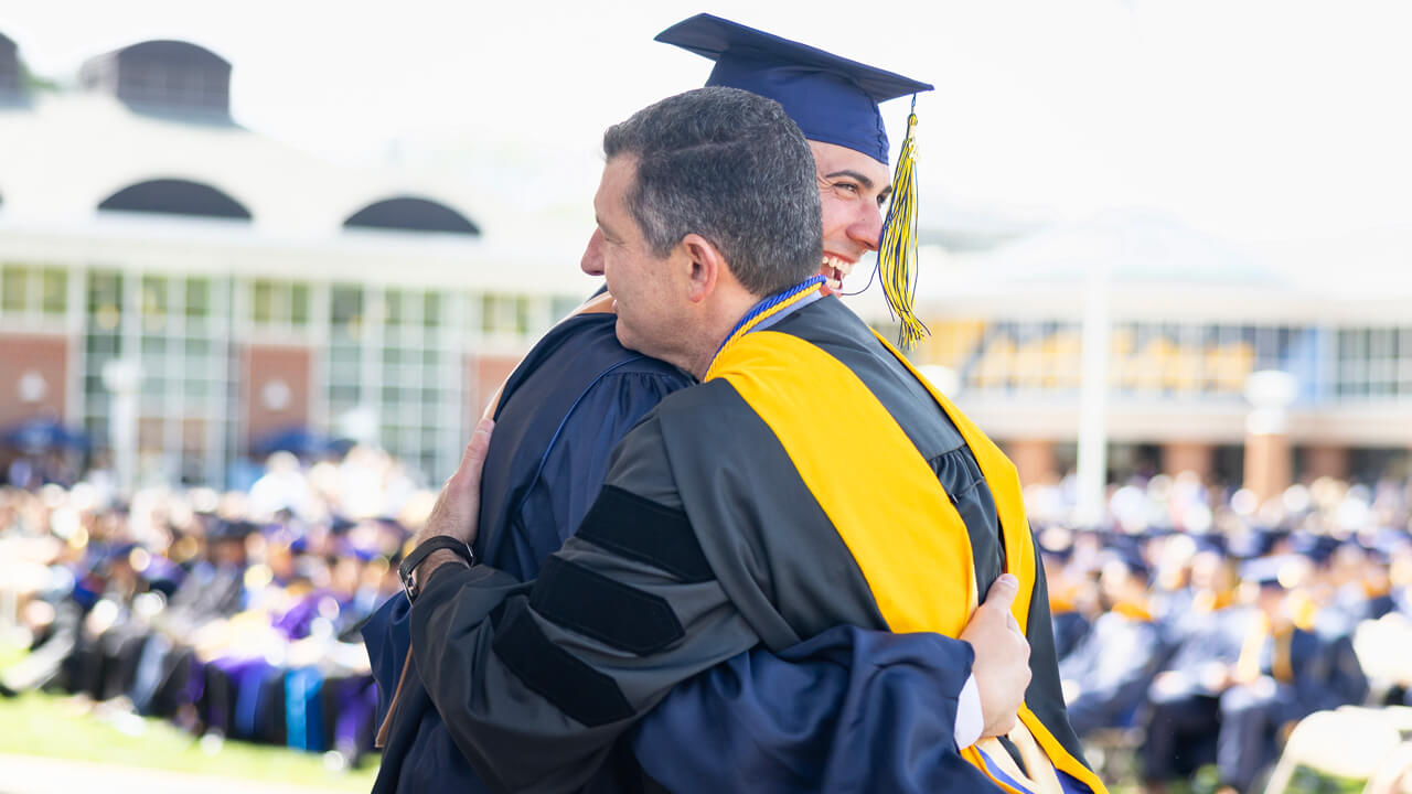 Student hugs professor