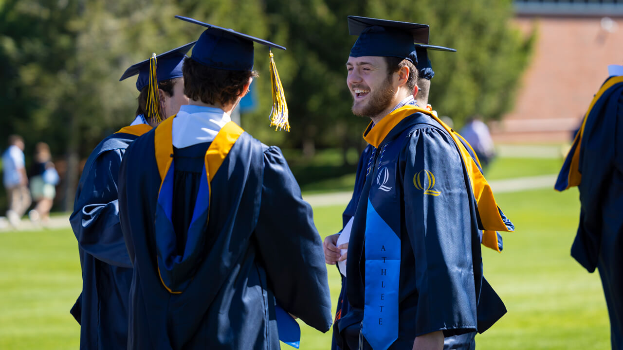 Students stand together talking