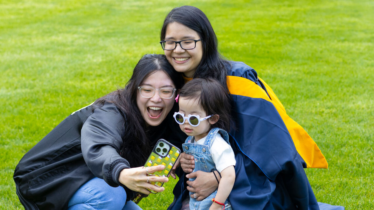 Graduate poses with friends for a selfie