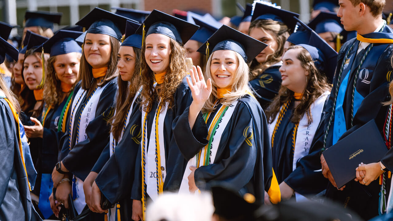 Students wave to camera