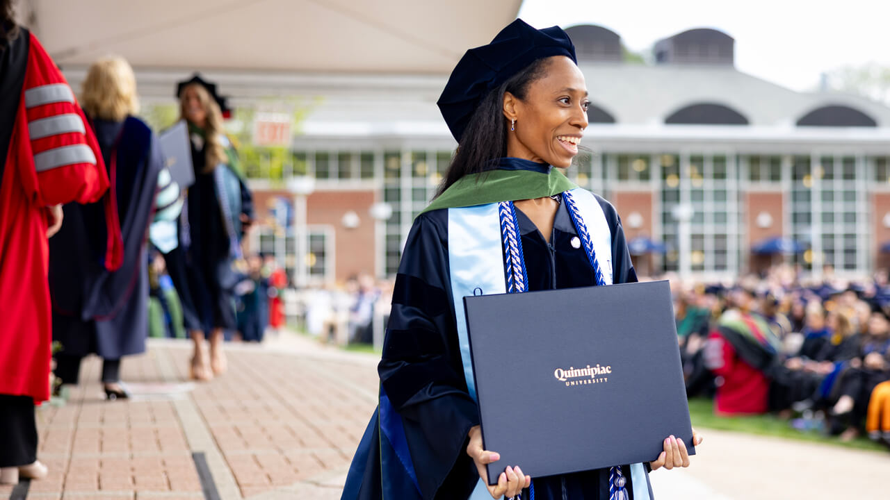 Student walks with degree