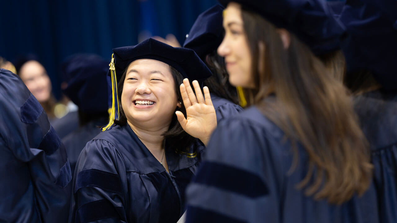 Medicine student smiling during class of 2024 medicine commencement