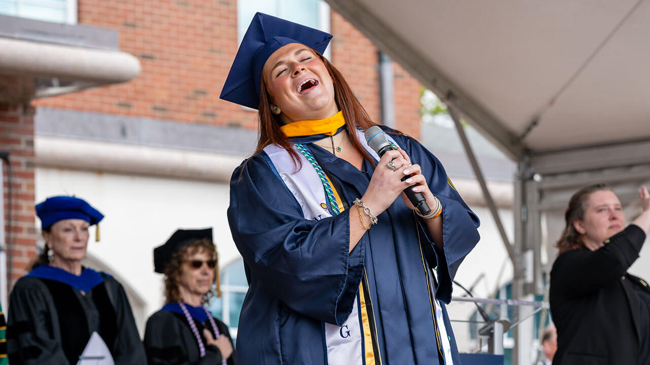 graduate sings the national anthem