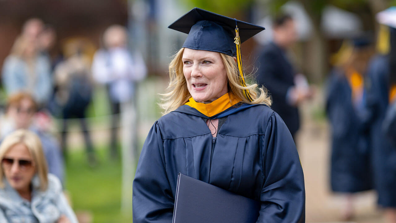 graduate smiles after crossing the stage