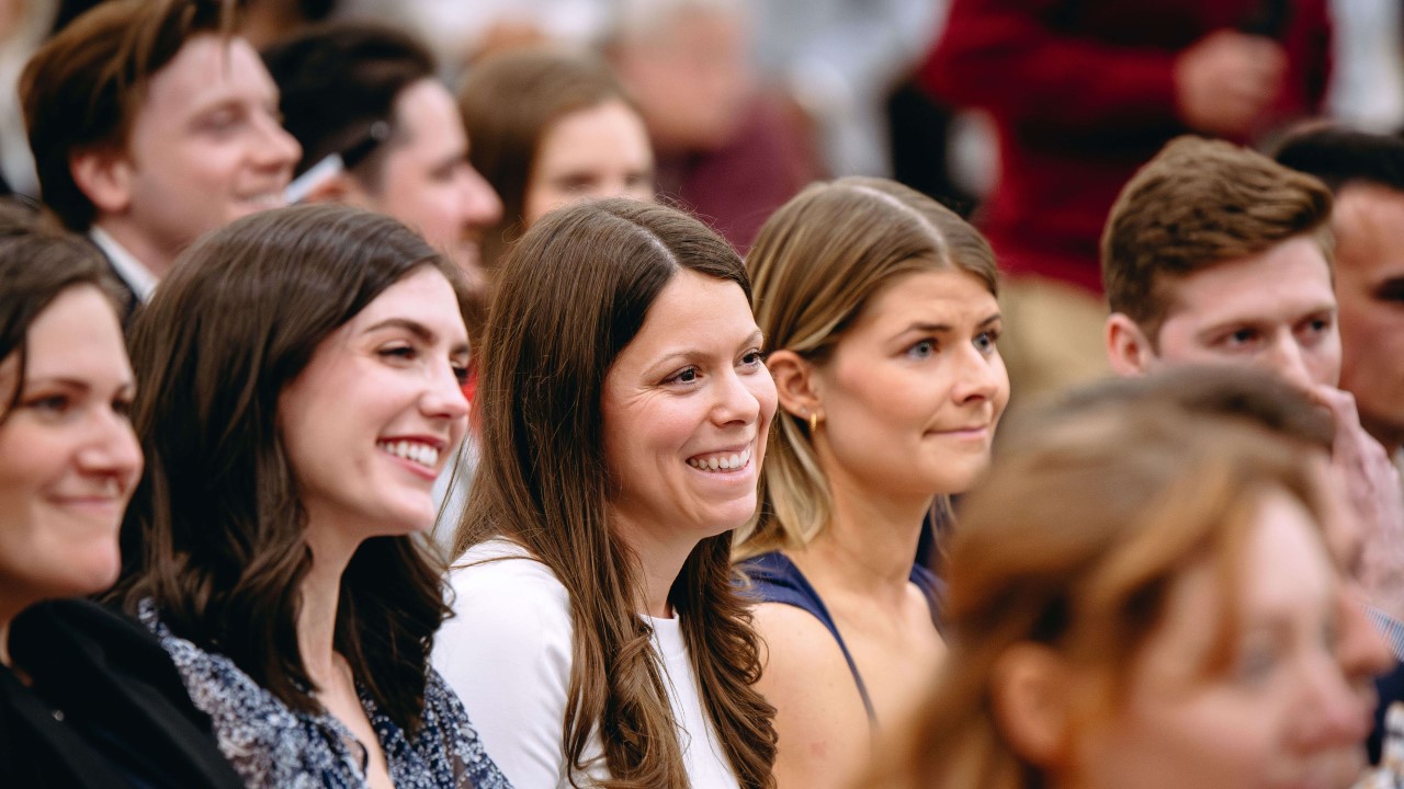 Several medical students smile from t heir seats during the Match ceremony