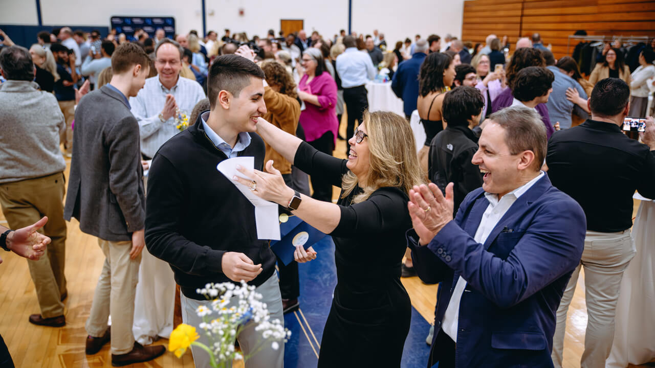 Quinnipaic student's parents welcome celebration with a hug