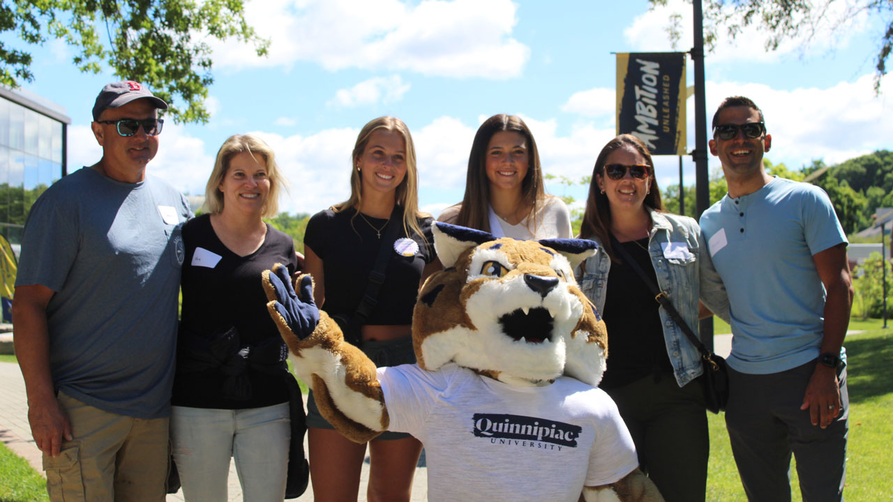 Boomer kneels in front of a group of people