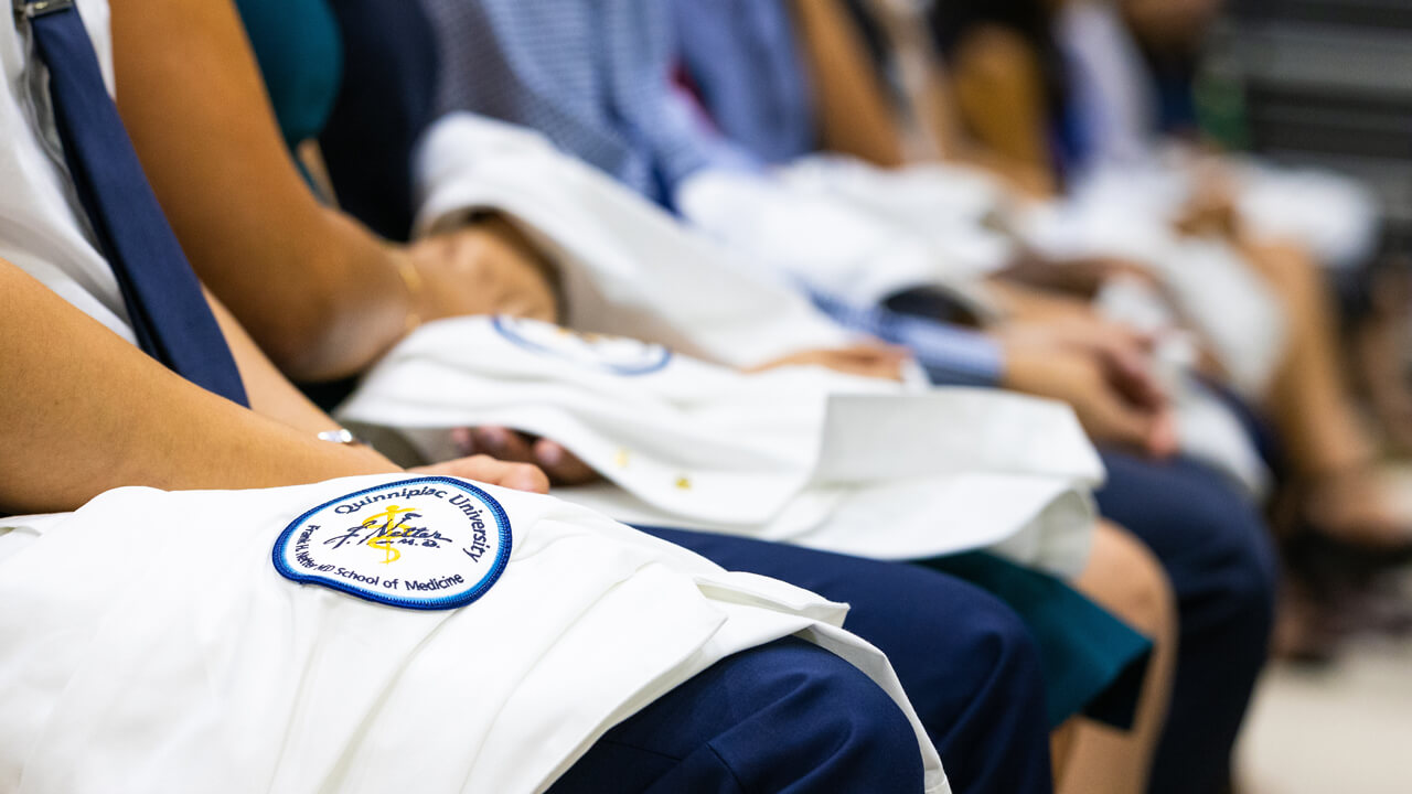 School of Medicine seal on the white coat