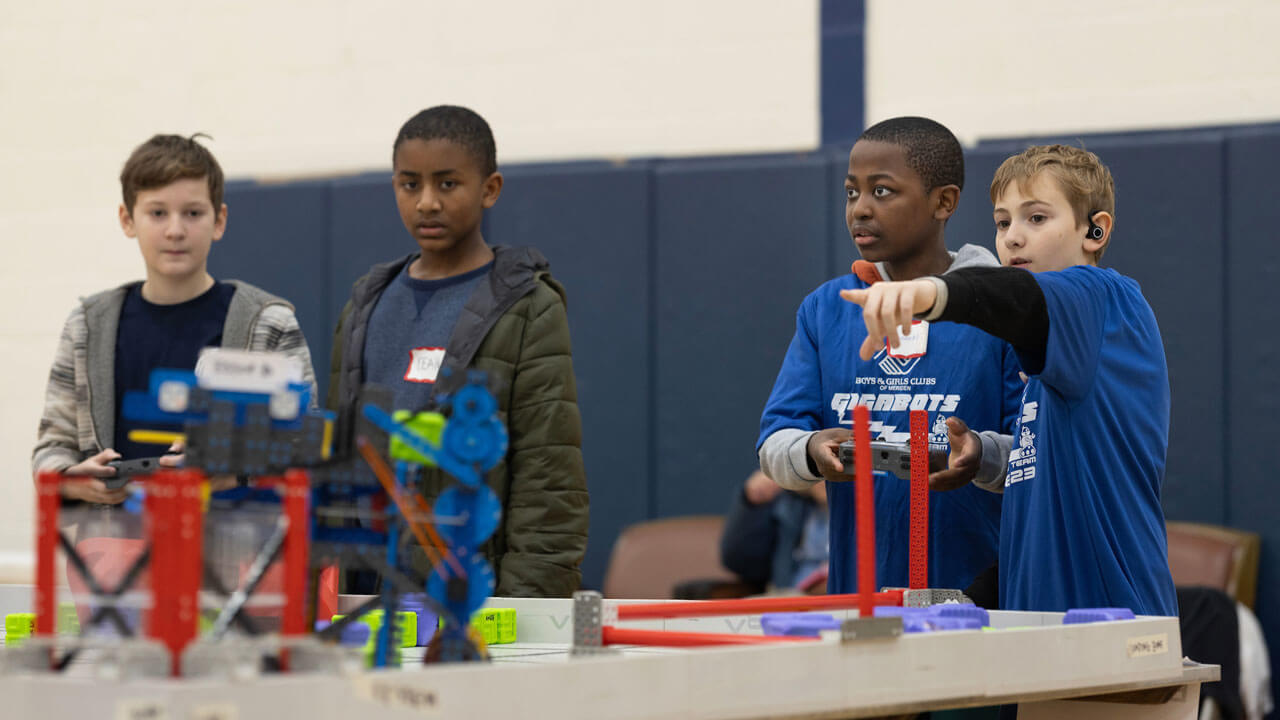 Students engaged in robotics competition in Burt Kahn Court at Quinnipiac