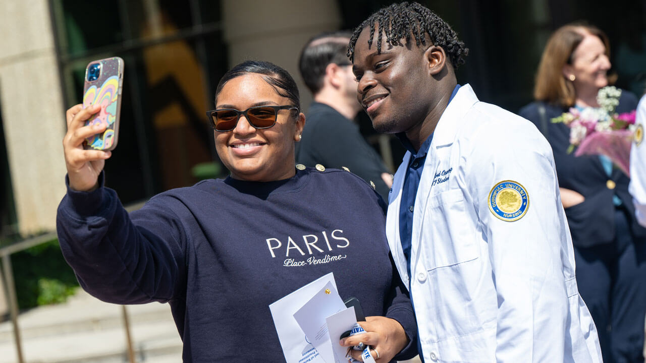 Nursing student family takes a photo outside of North Haven Campus