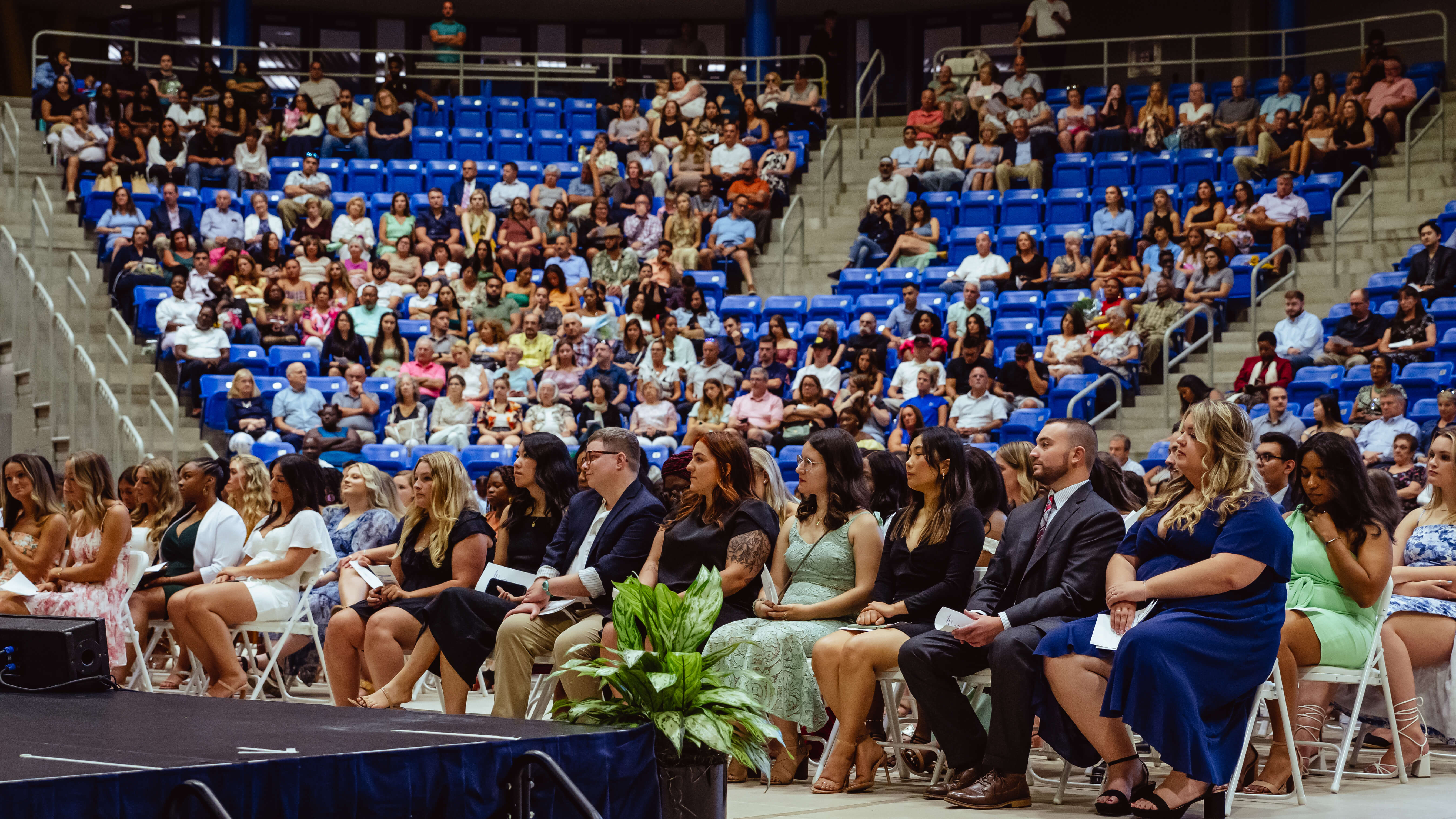 Graduates look at the stage