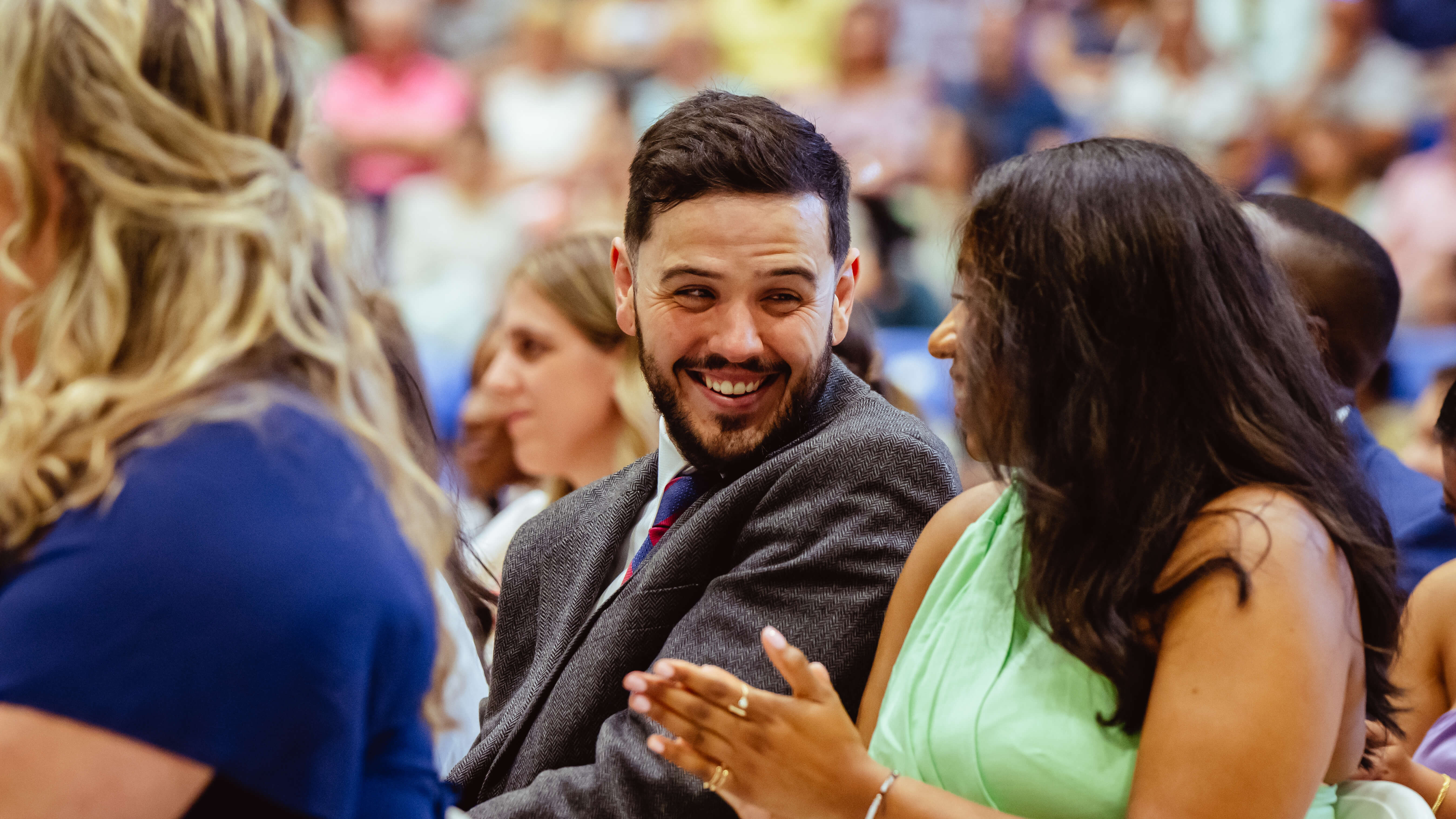 Graduates smile at one another