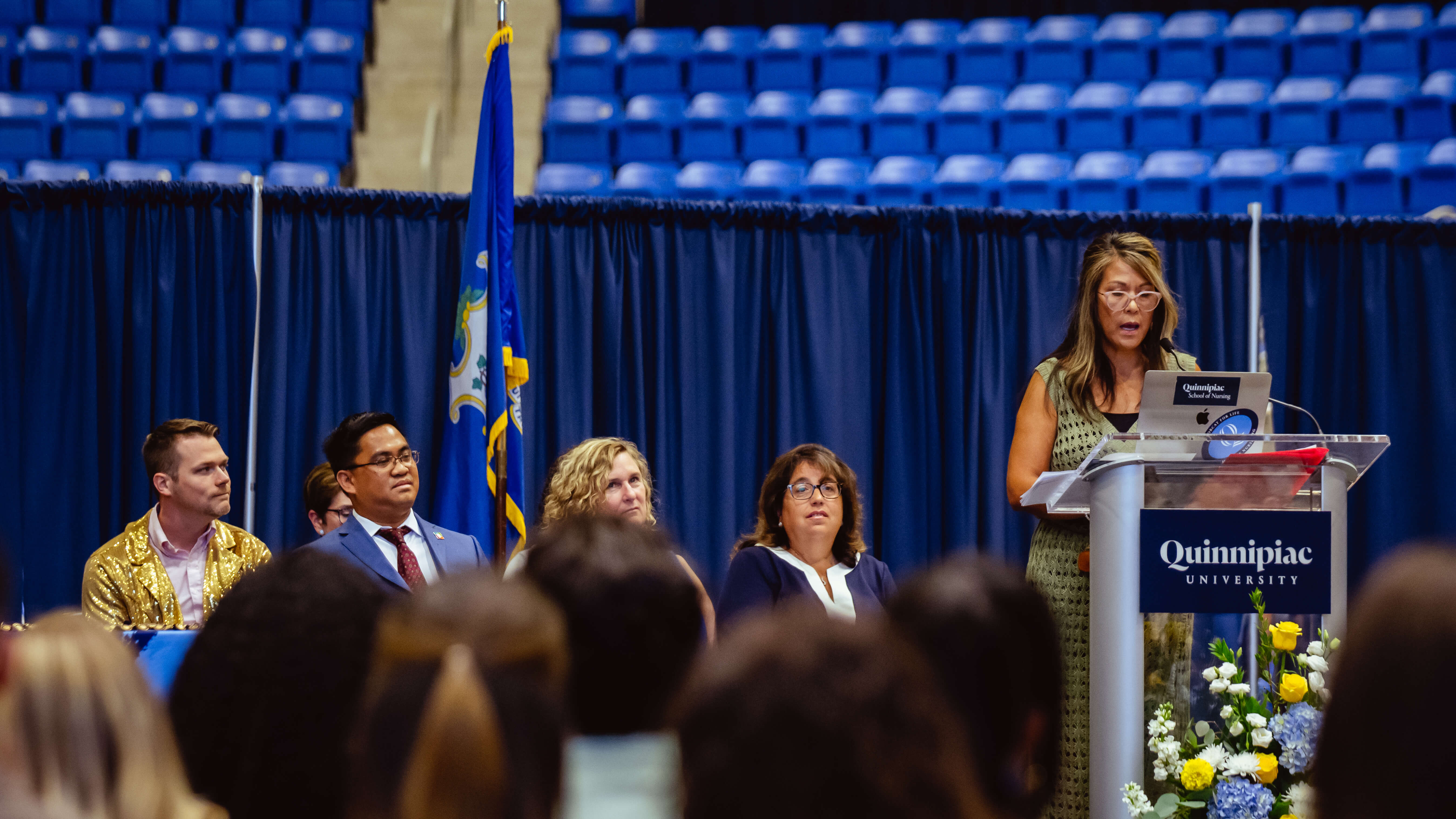 A speaker address a speech to the nursing graduates and their families