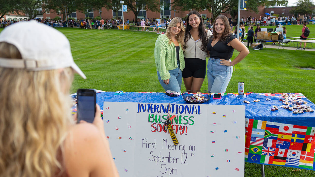 Students explore the International Business Society table at the Engagement Fair