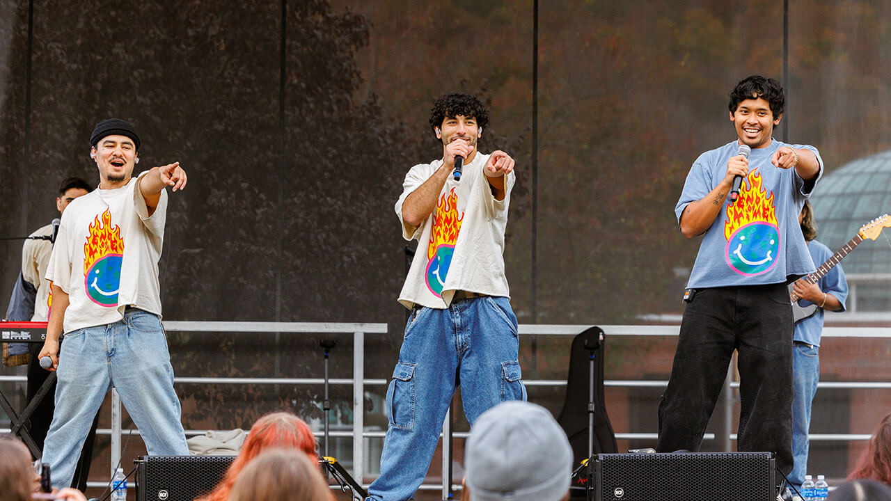 Peach Tree Rascals singing on stage while pointing to the crowd