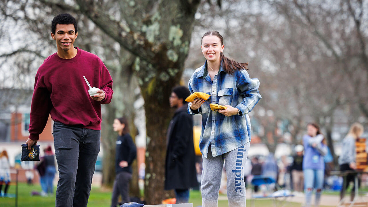 Fall Fest attendees playing corn hole on the quad