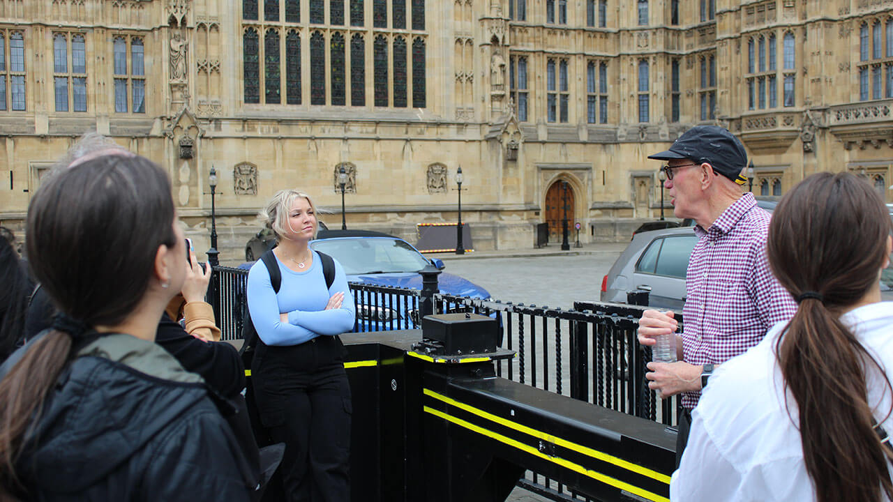 group of students watch a tour guide