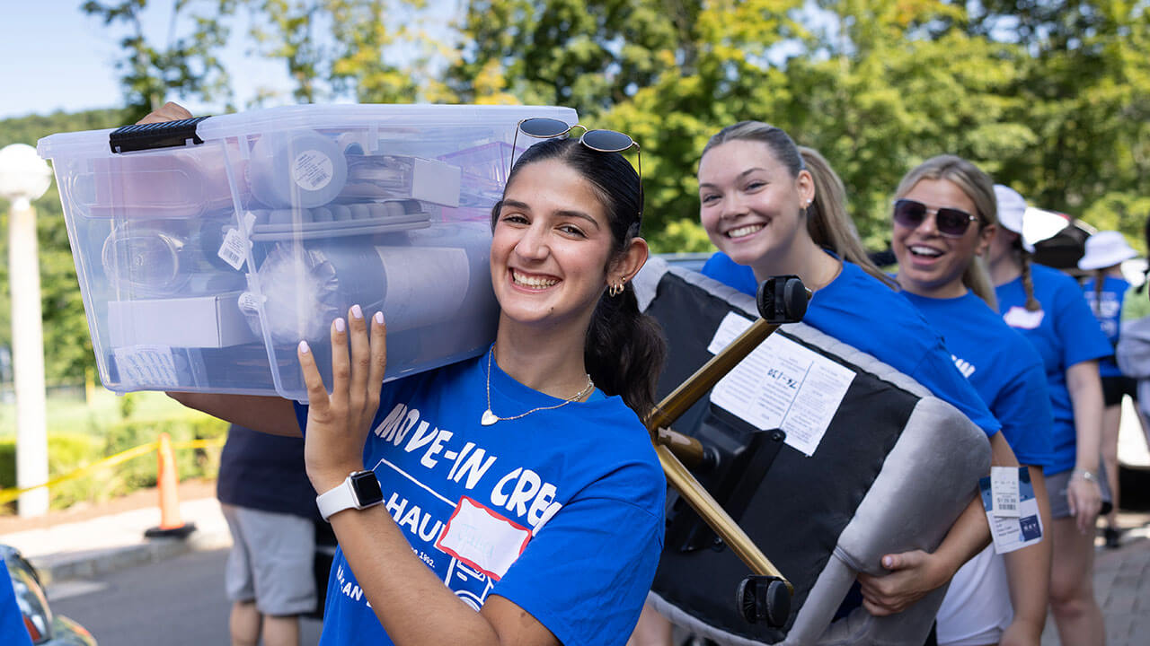 Students carry boxes down Bobcat Way