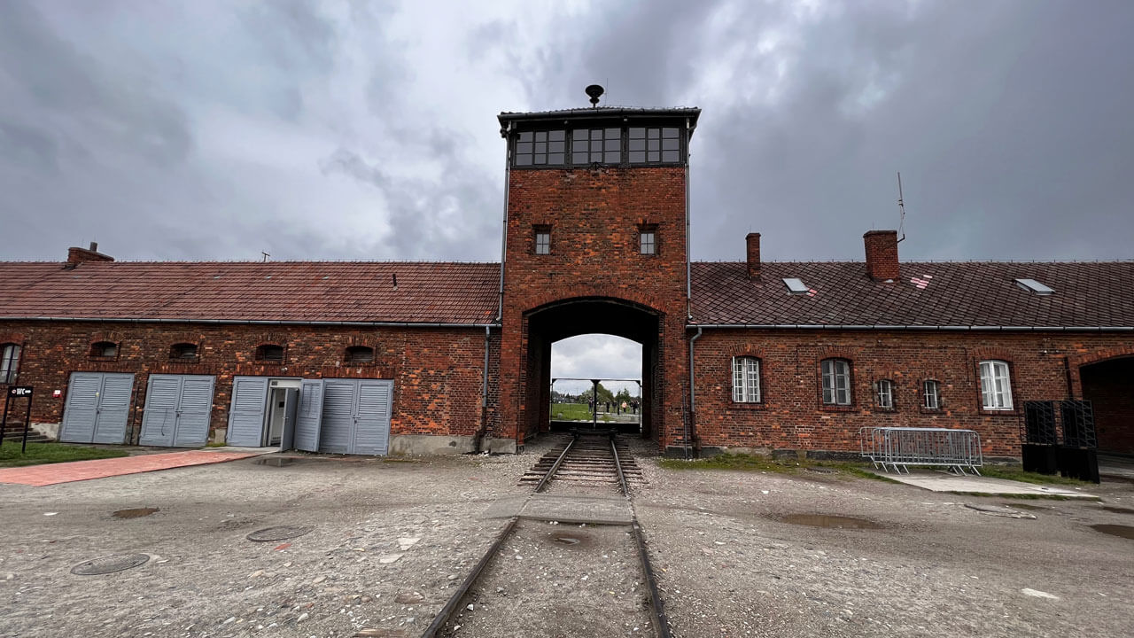 Brick building with half broken rail road entering inside