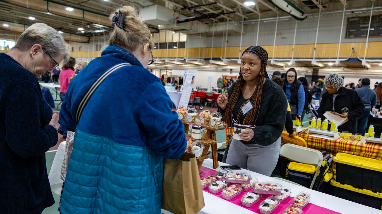 A vendor selling sweets talks to customers.