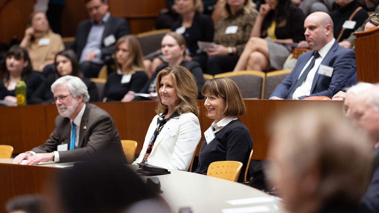 An audience attends a gallery exhibit event in the Quinnipiac School of Law courtroom