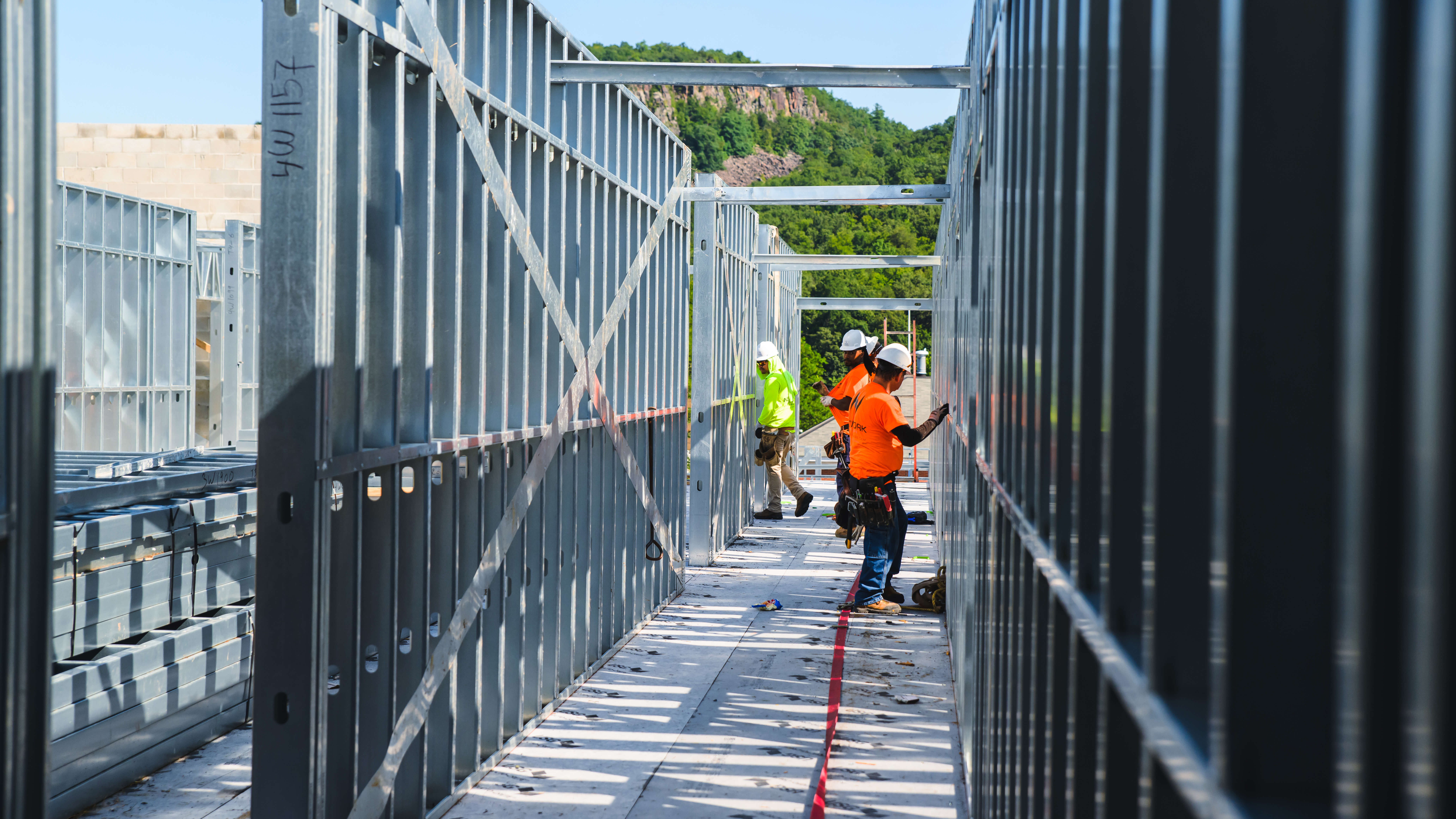 Workers stand amongst the structure