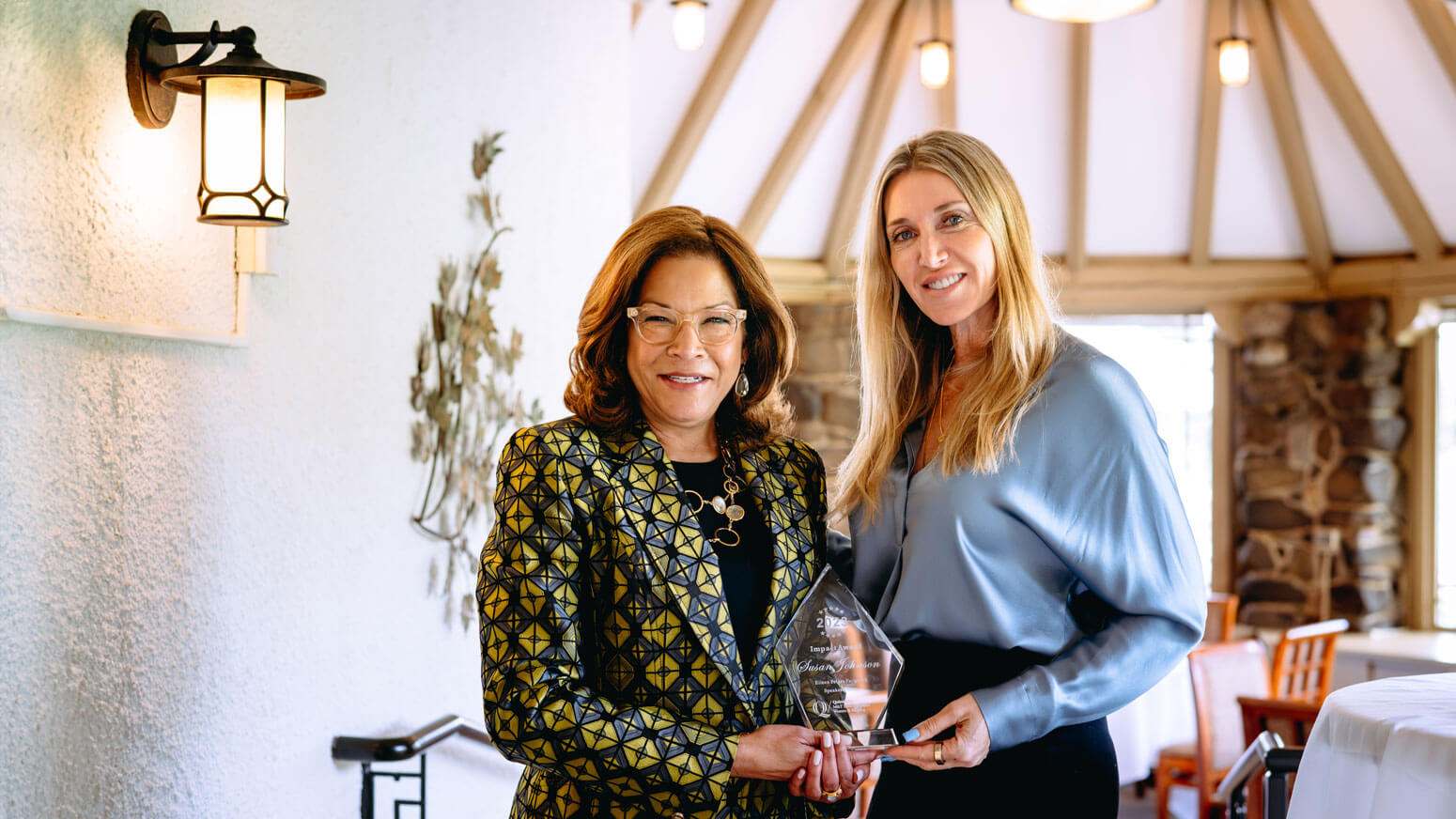 Jessica Geis and Susan L. Johnson holding the award