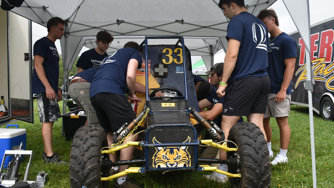 The Baja Project team working on the vehicle