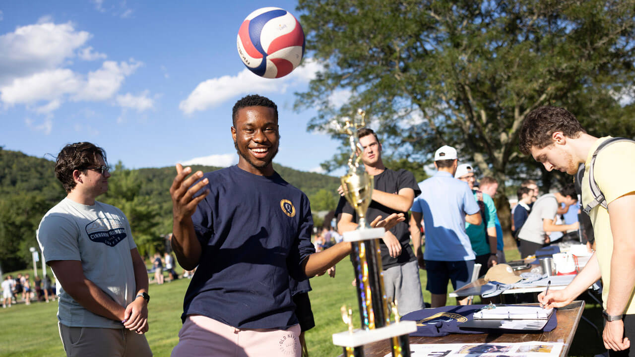 Organization table playing with a volleyball and a trophy on their table