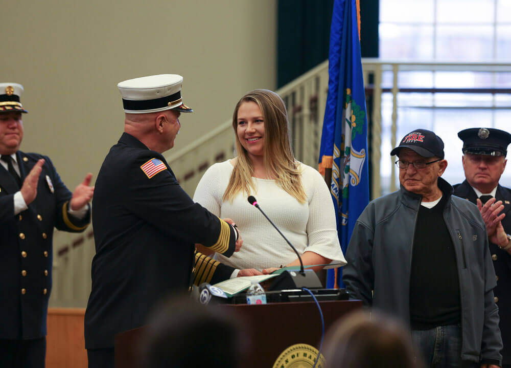 Vander May shaking hands with Hamden Fire Chief at podium