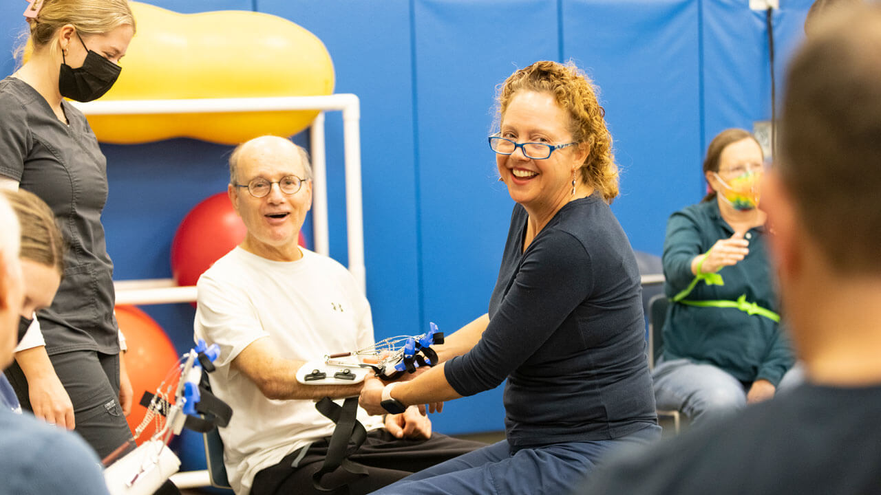 StrokeOT founder Carolyn Brown works with stroke survivors in the Quinnipiac University Movement Lab