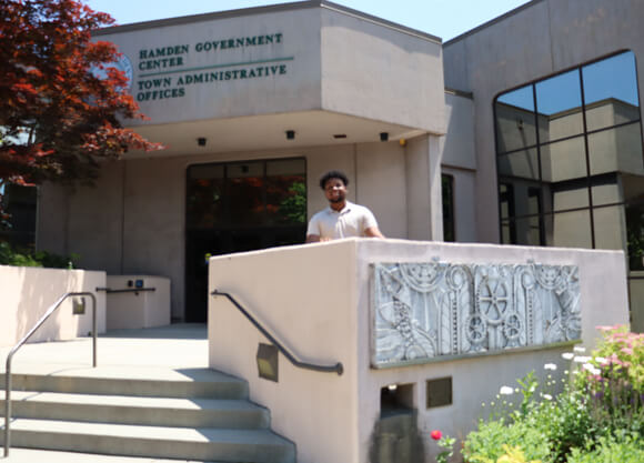 Jayden Hutchion stands in front of building